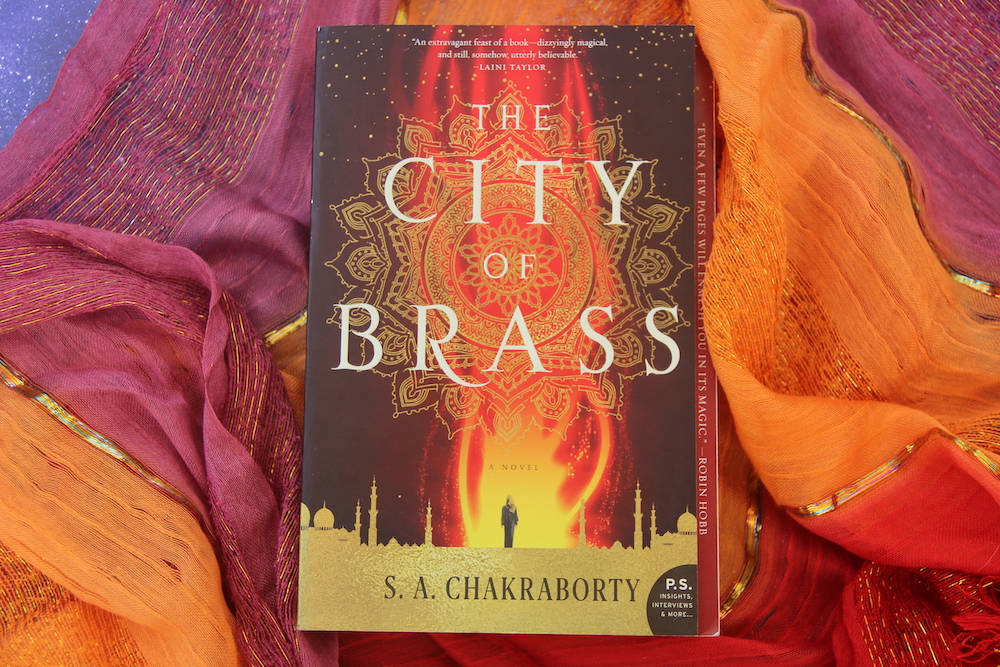 Novel CITY OF BRASS on multicolored fabric