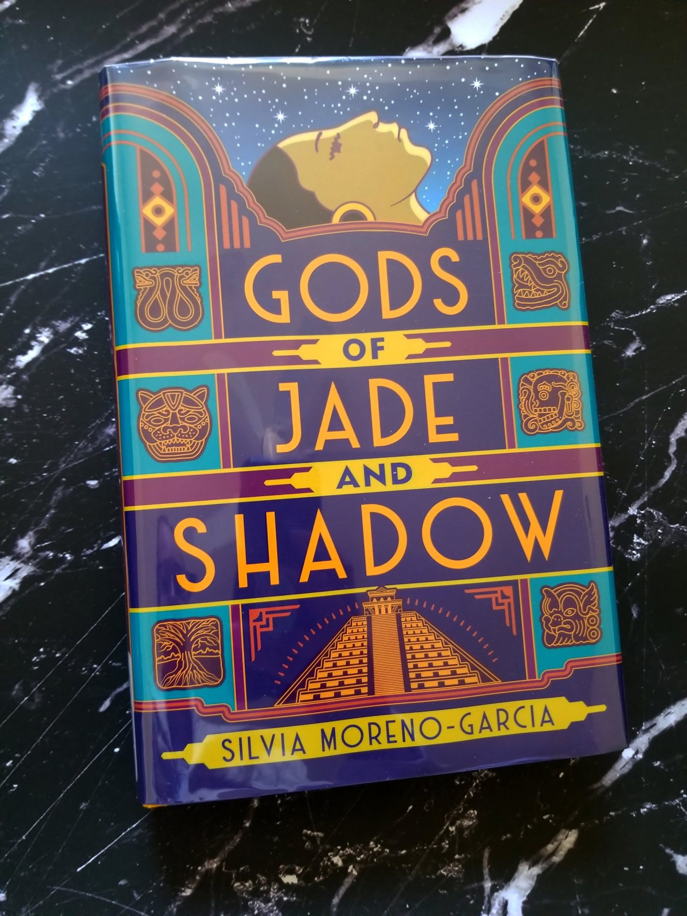 Book Gods of Jade and Shadow on a black marble background