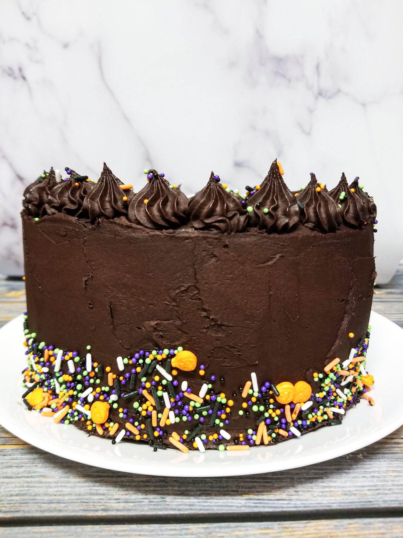Chocolate cake with Halloween sprinkles around the base
