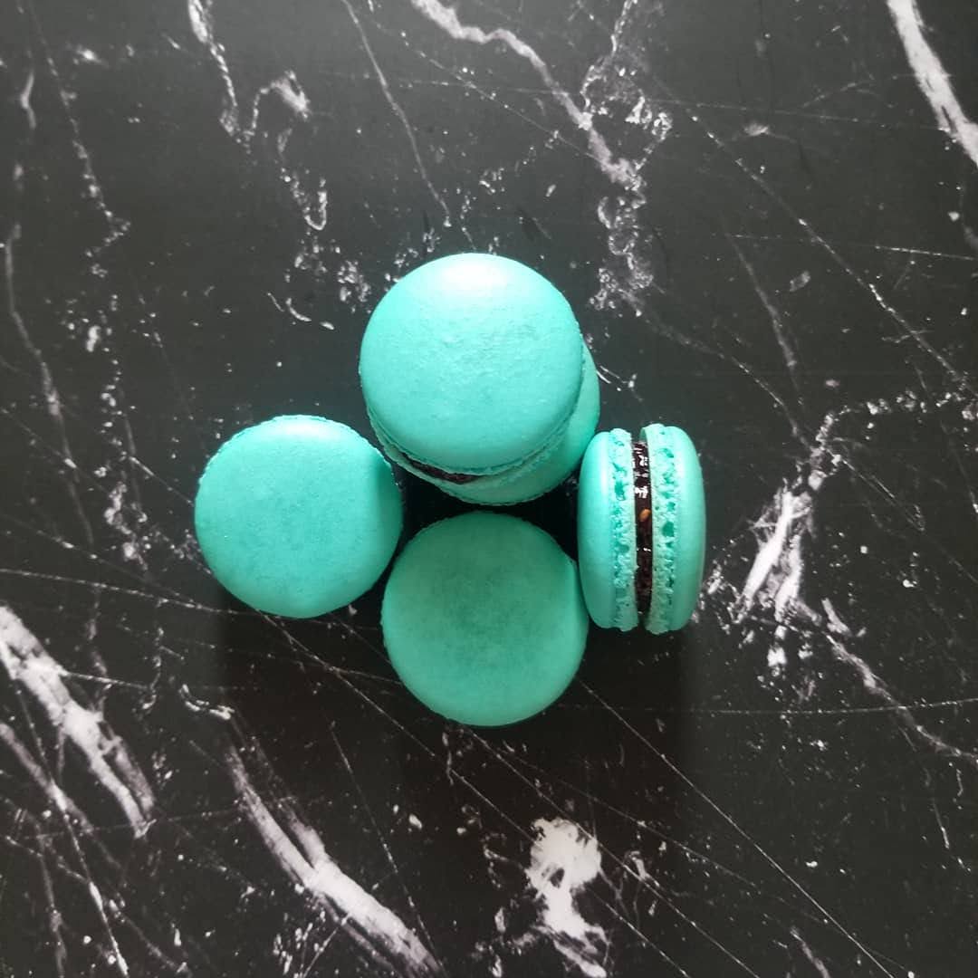 blue macarons on a black marble background