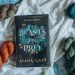 Hardcover version of BoP surrounded by orange, green, and teal skeins of yarn, sits on top of a white cloth and blue marble background