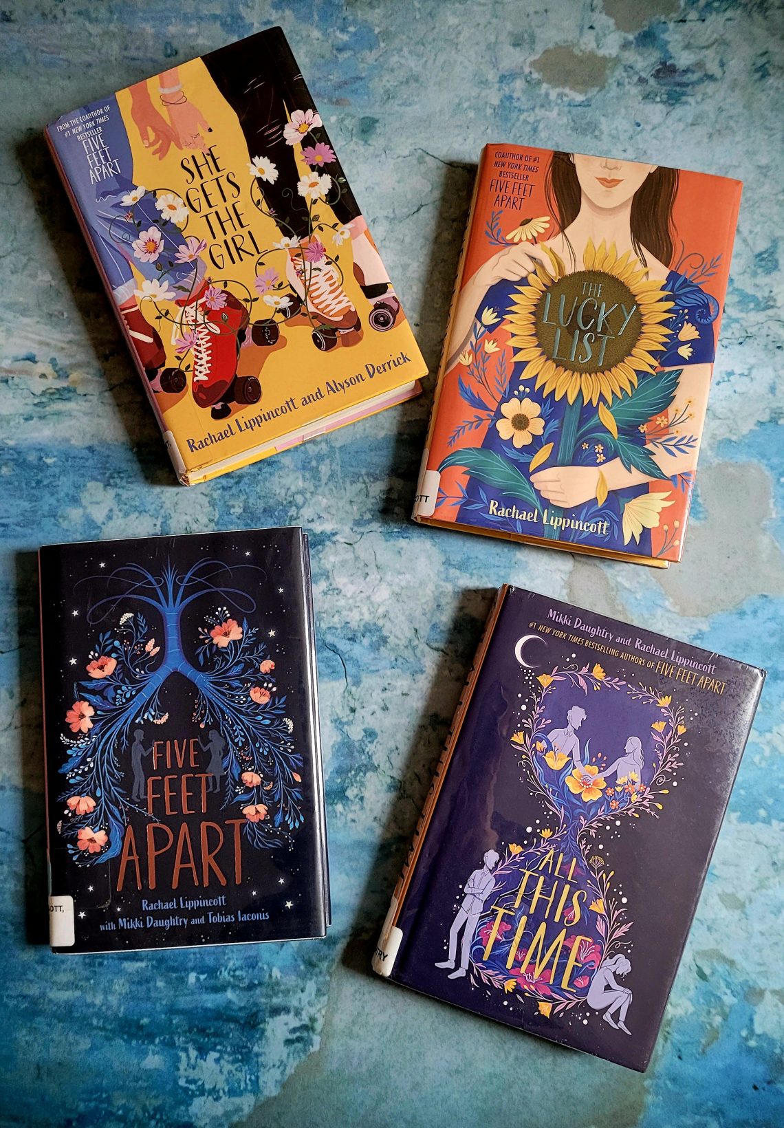 A flatlay of 4 books by Rachael Lippincott