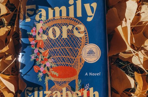 Hardcover copy of Family Lore by Elizabeth Acevedo in a pile of golden leaves